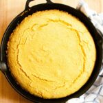 Cornbread baked in a cast iron pan.