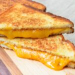 Grilled Cheese Sandwiches on a wooden cutting board