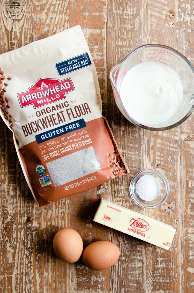 Ingredients for buckwheat crêpes on a wooden table.
