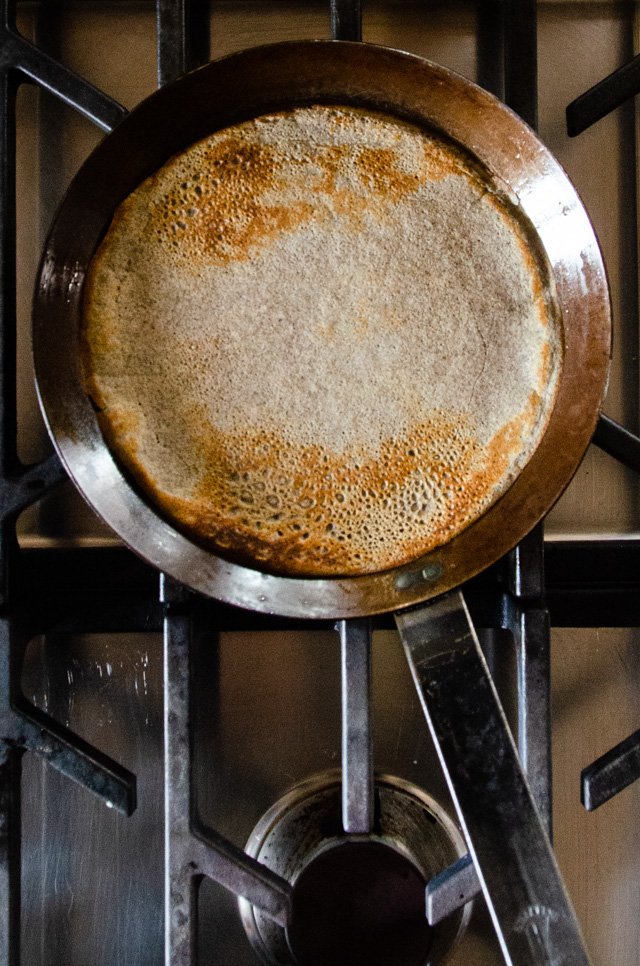 Buckwheat crêpe batter in a traditional crêpe pan.