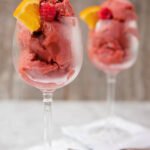 Sangria sorbet in white glasses with napkins and spoons.