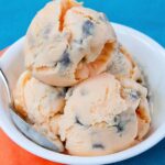 Tiger Tail Frozen Yogurt in a white bowl on a blue background.