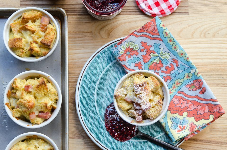 Monte cristo bread pudding on a green plate with three more on a baking sheet.