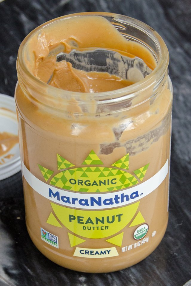 Organic Peanut Butter jar on black marble.