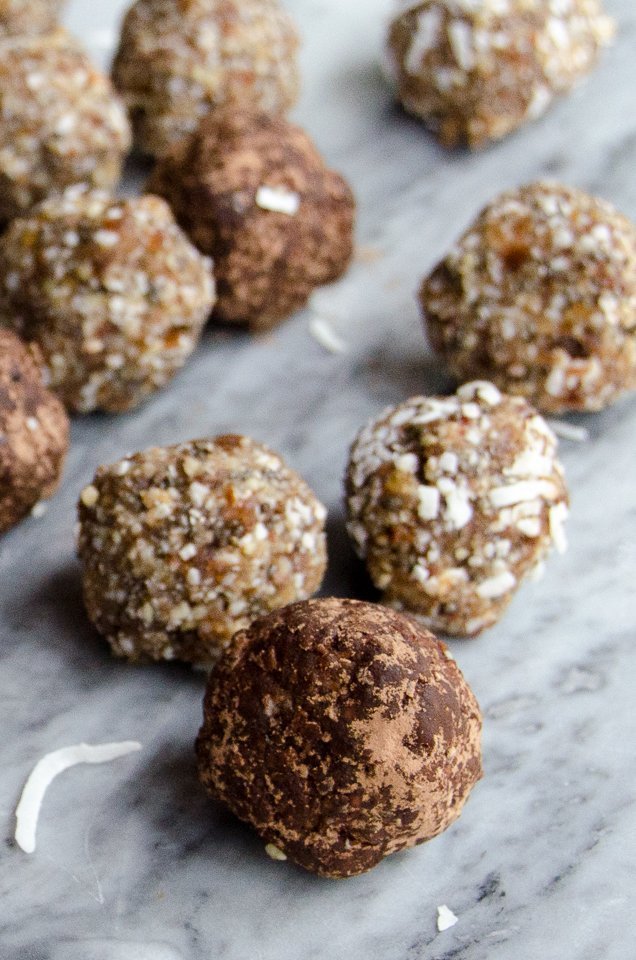 Paleo Power Bites scattered on a grey marble surface.