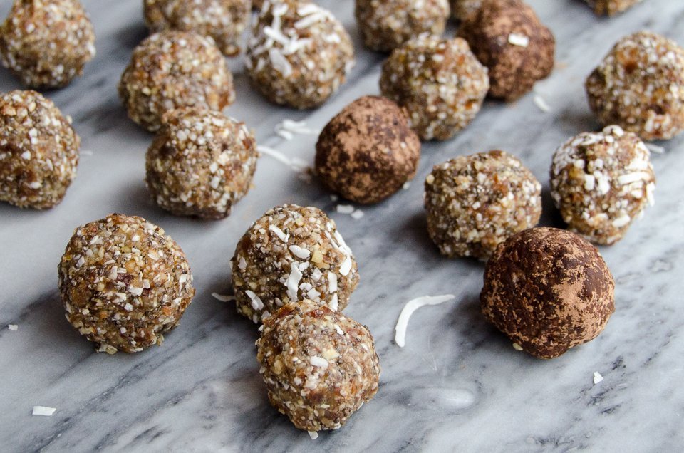 Paleo Power Bites scattered on a grey marble surface.