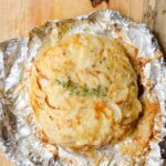 Potato Galette on foil on a wooden counter.