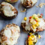 BBQ Chicken Stuffed Potato Skins on a grey marble background.