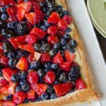 Mixed Berry Tart on a white rectangular plate.