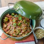 Pork and Pumpkin chili in a green cast iron pot.