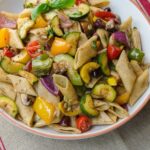 Roasted Vegetable Pasta Salad in a bowl on burlap.