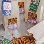 Sweet and Salty Snack Mix in brown paper bags with ribbons and tags.