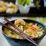Asian Shrimp Noodle Soup in a deep bowl with chopsticks.