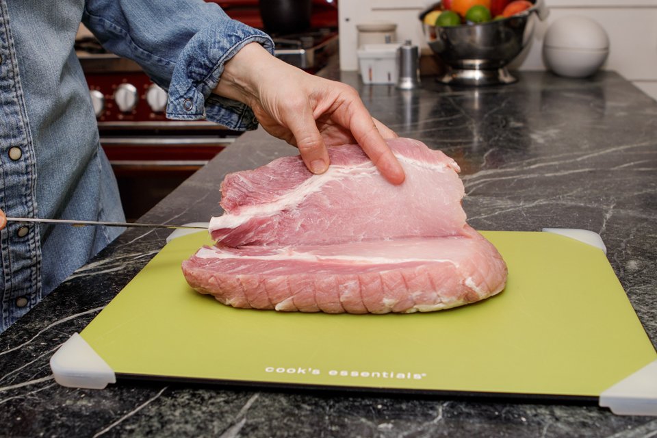 Showing how to double-butterfly a pork loin.