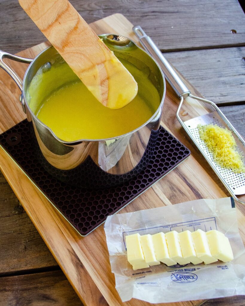 Lemon curd coating the back of a wooden spoon..