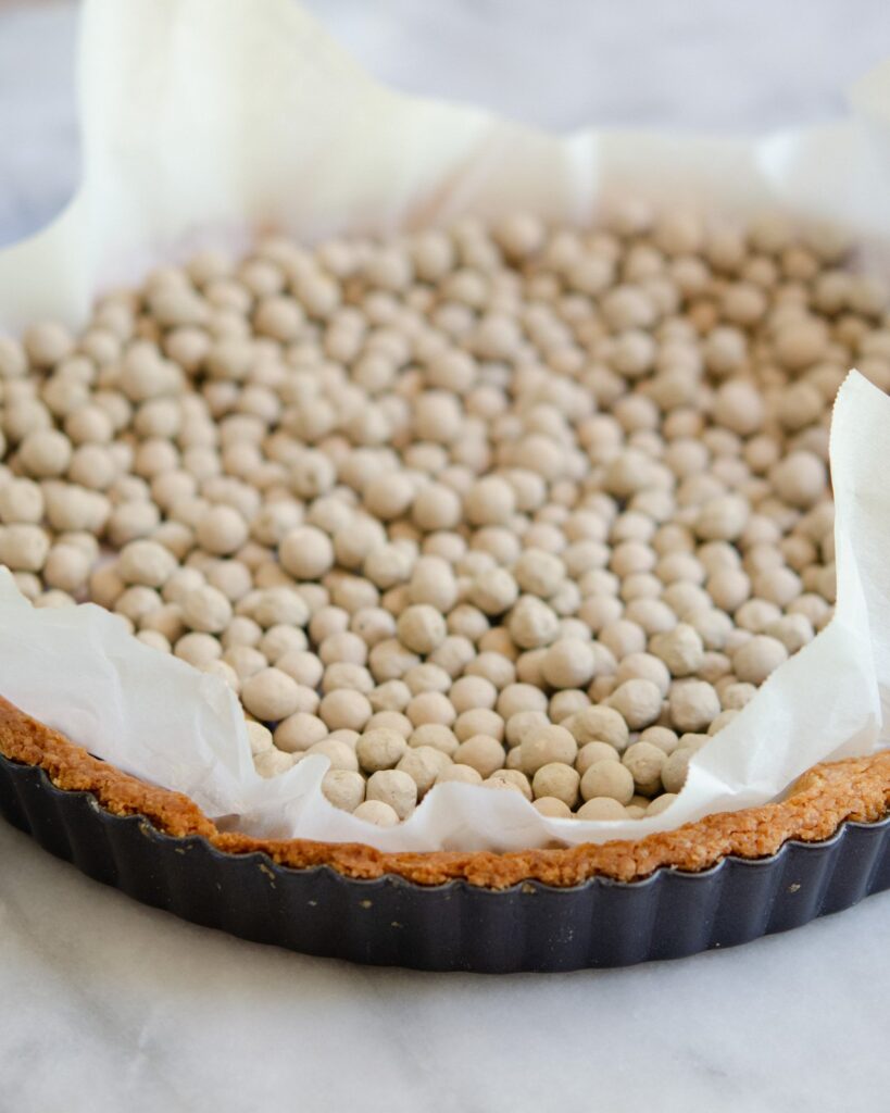 Blind baking a tart shell with pie weights.