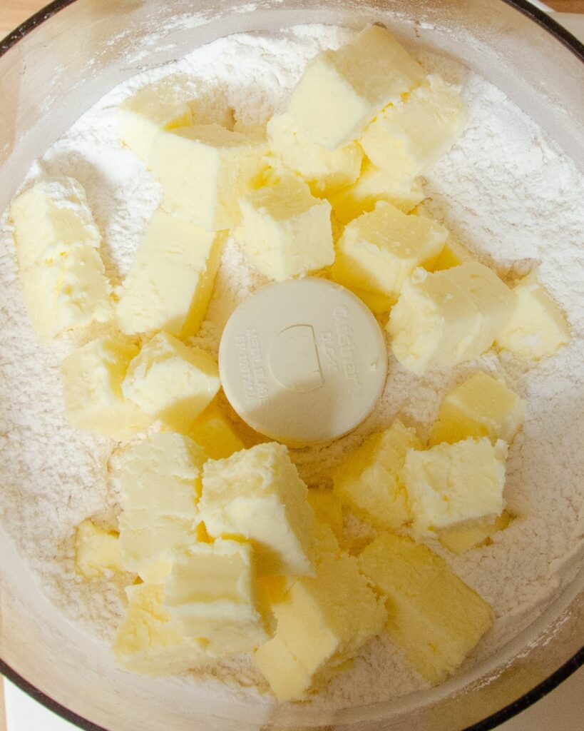 Chunks of butter in flour in a food processor.