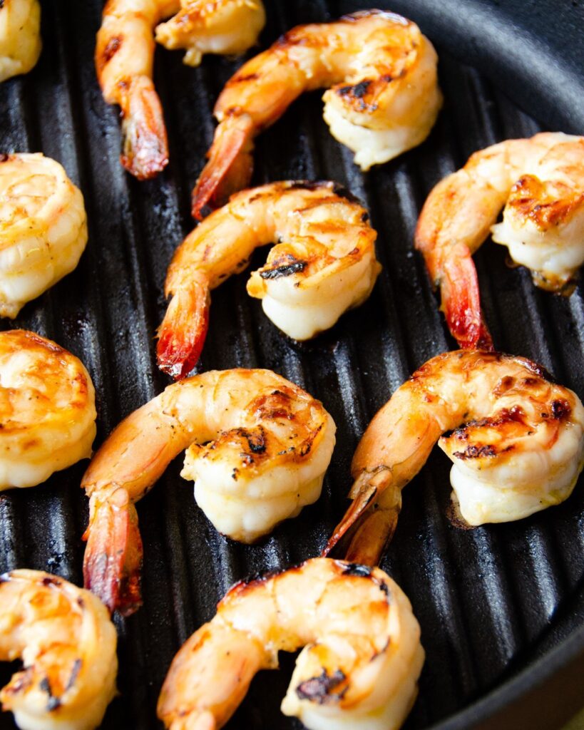 Shrimp grilling on a grill pan.