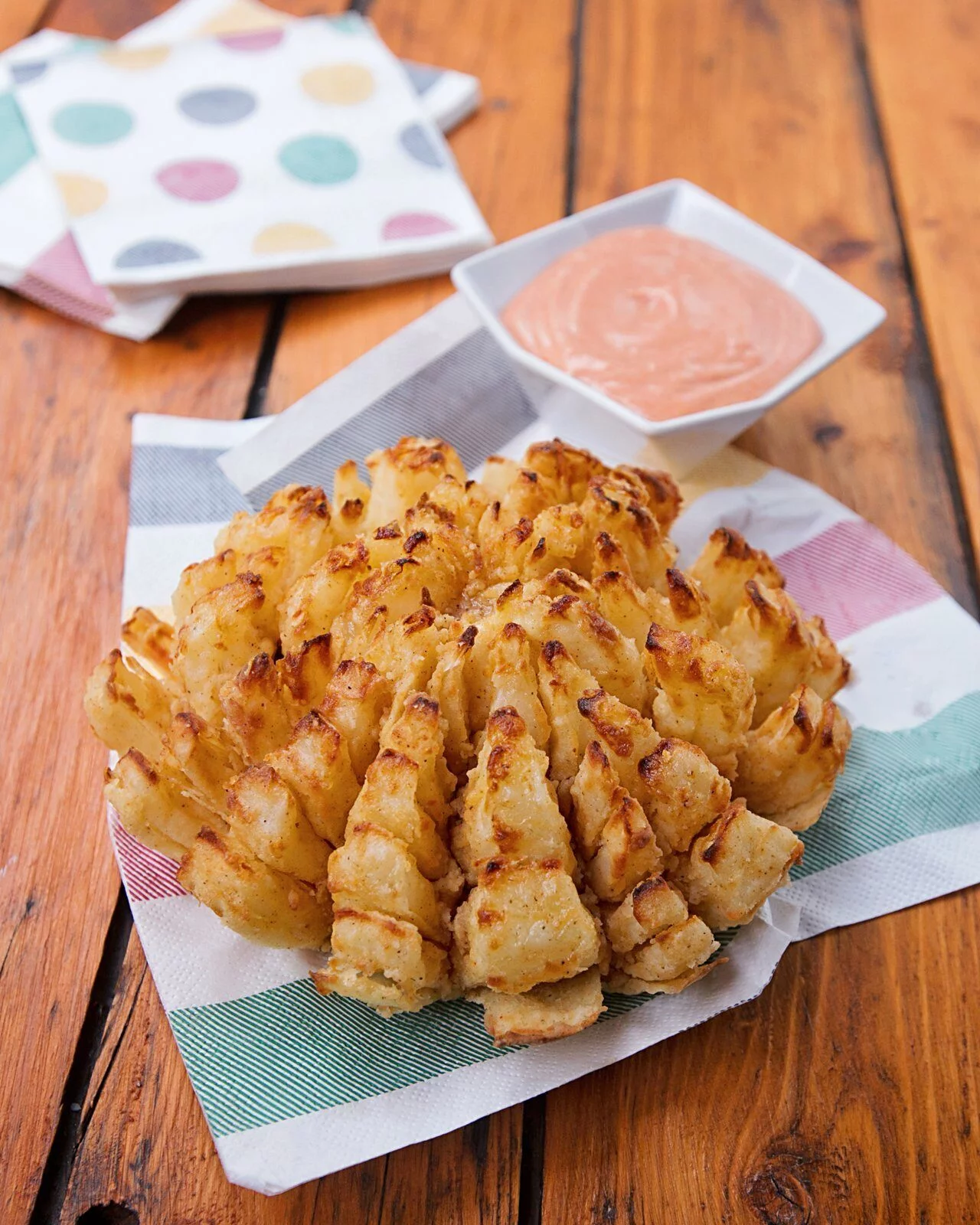 Air fryer blooming onion crispy with spiced flour coating dipping sauce for Memorial Day impressive side