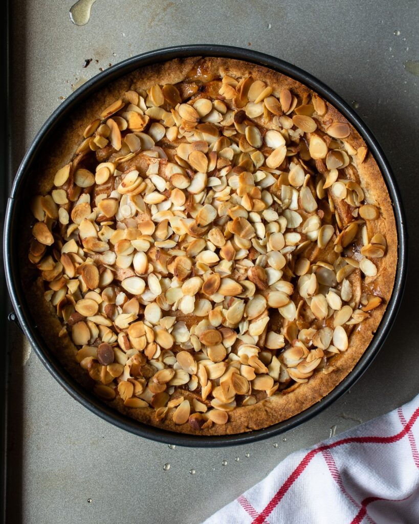 Apple almond torte right out of the oven on a baking sheet.