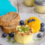 Sous Vide Egg Bites on a plate with toast and some fruit.