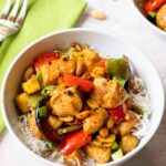 Kung Pao Chicken and Vegetables in a white bowl with a green napkin.