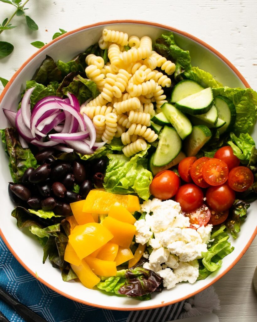 Salad ingredients in a white bowl.