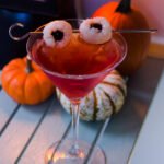 Pama Lychee-tini on a table with little pumpkins behind.