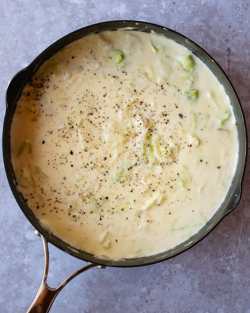 Cheese sauce in a saute pan.