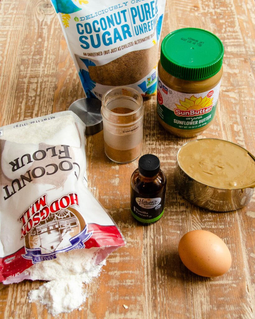Ingredients for sunbutter cookies on a wooden table.