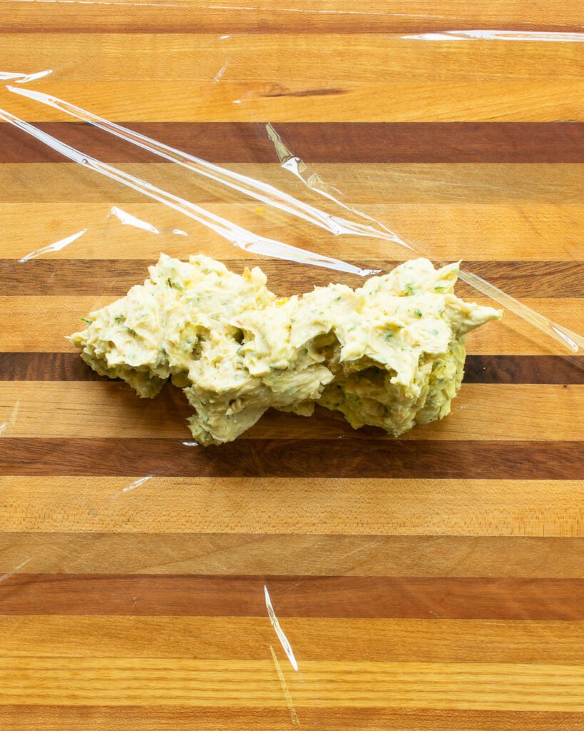 Compound butter on a piece of plastic wrap before being rolled.