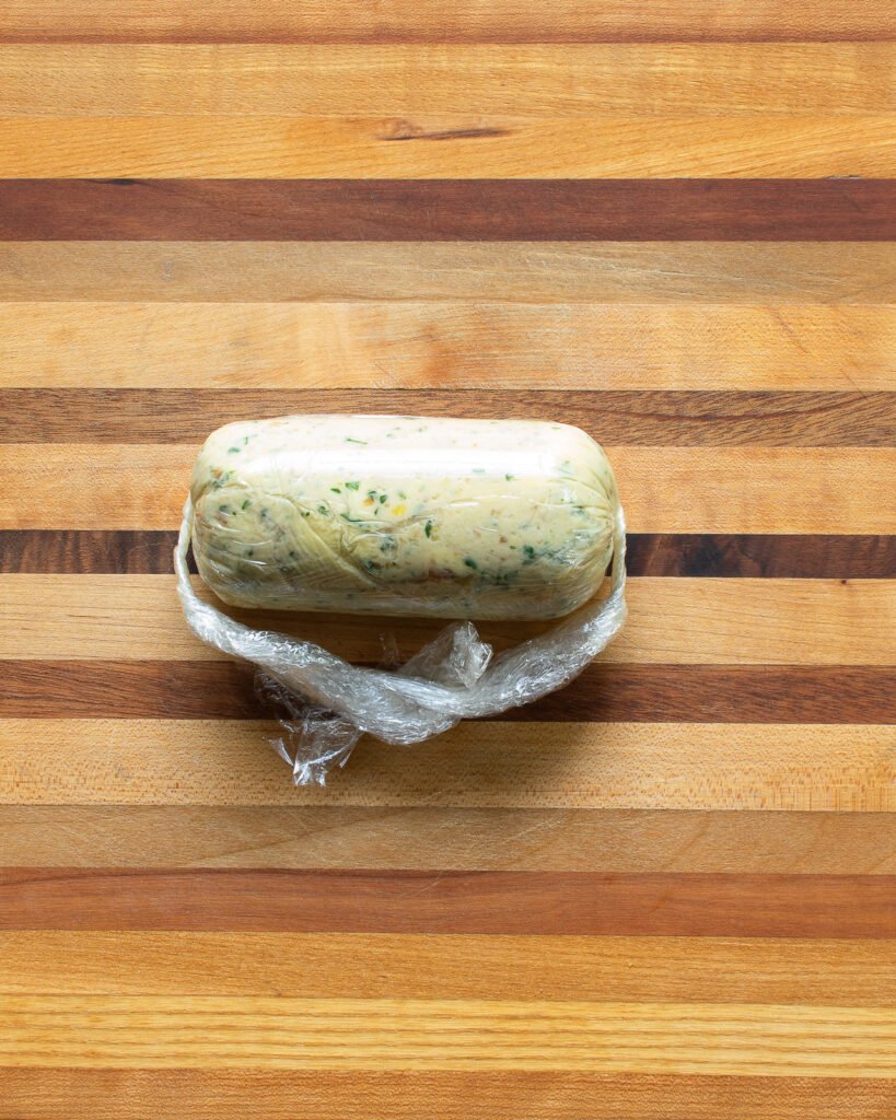 Compound butter rolled up in a log in plastic wrap.
