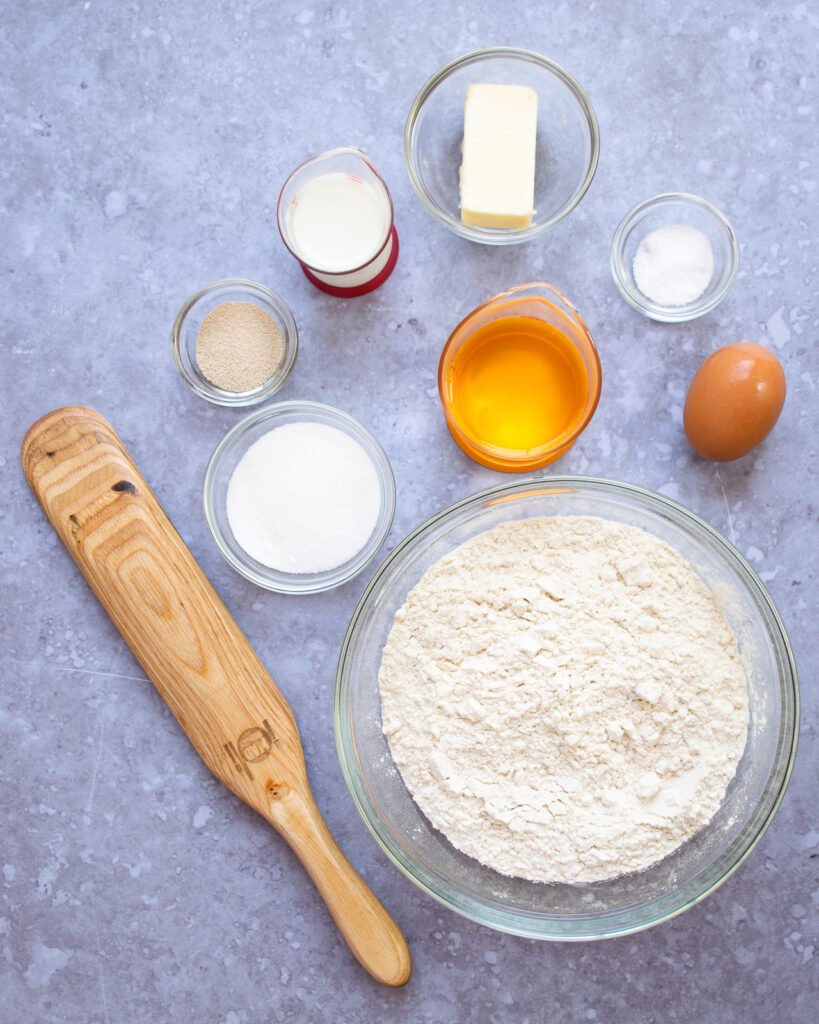 Ingredients on a grey counter with a wooden spoon.