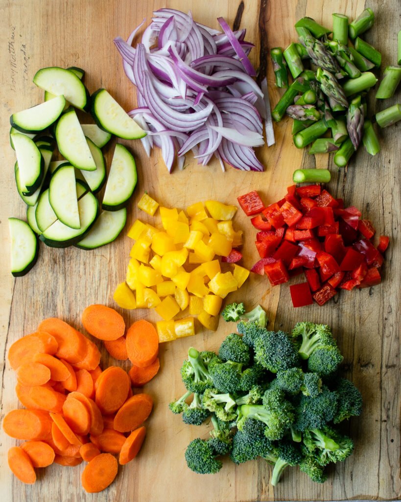 Cut up vegetables on a cutting board.