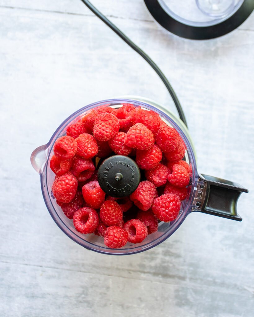 Raspberries in a mini chopper.