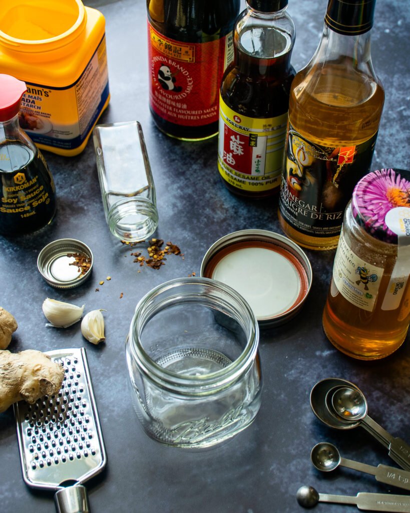 Ingredients surrounding an empty mason jar on a countertop.