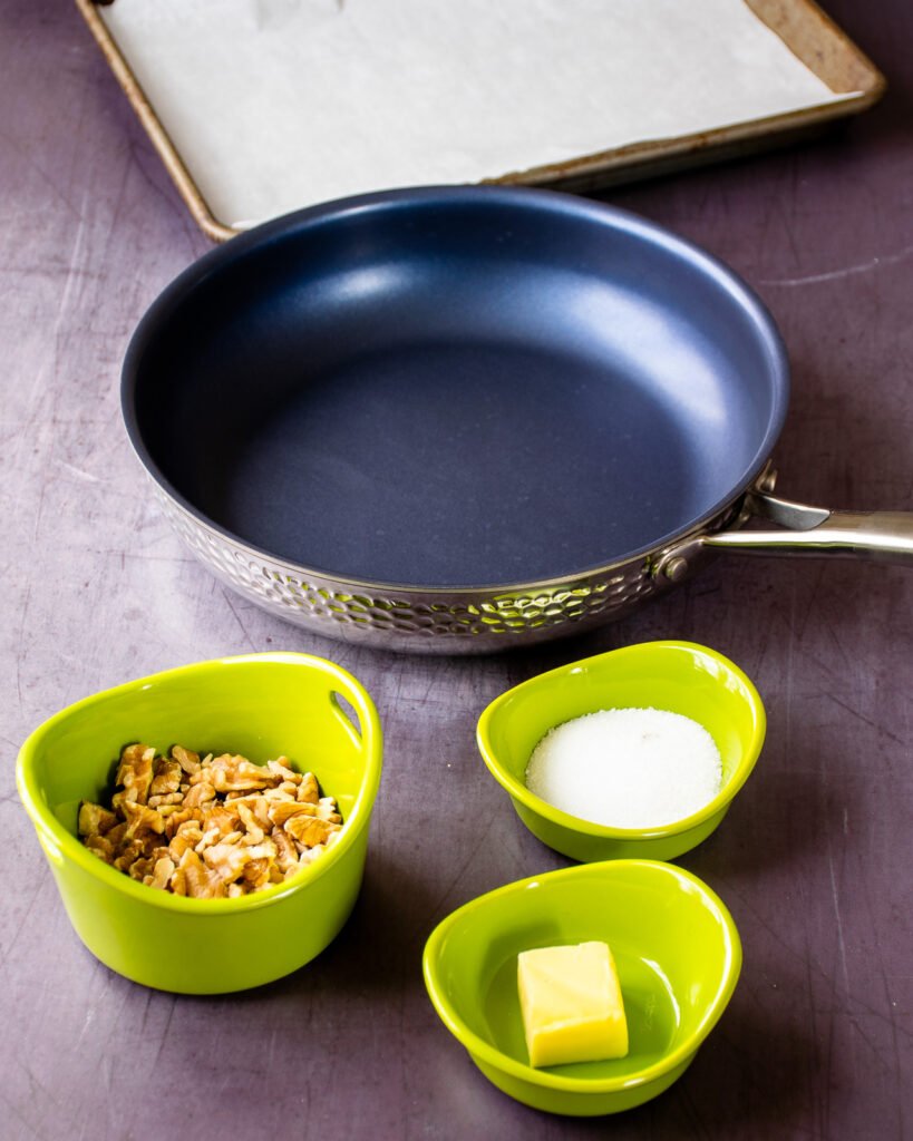 Three green ramekins with ingredients and a blue non-stick skillet.