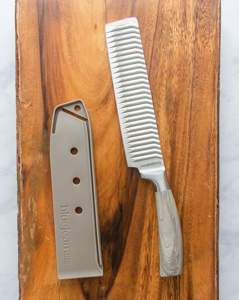 a nakiri knife and sheath with a gray handle