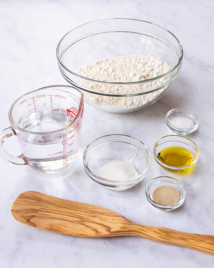 Stirring bread ingredients with a wooden spoon