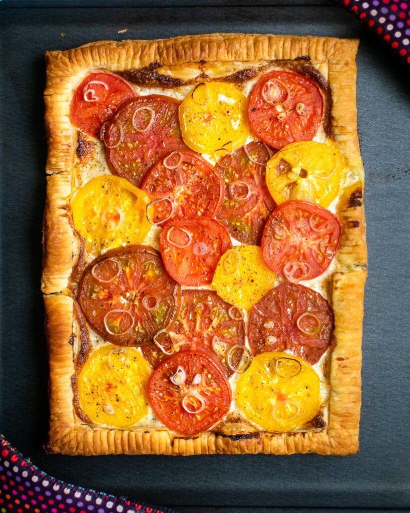 Baked easy summer tomato tart on a baking sheet.