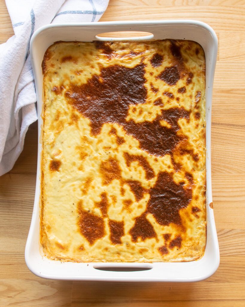 Baked moussaka in a white rectangular baking pan.