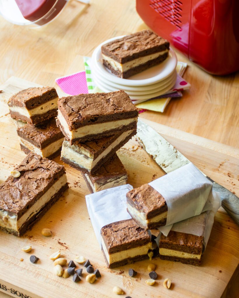 Looking down on a cutting board with peanut butter brownie ice cream sandwiches.