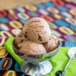 Double Chocolate Ice Cream in a silver ice cream dish with a spoon and agreen napkin.