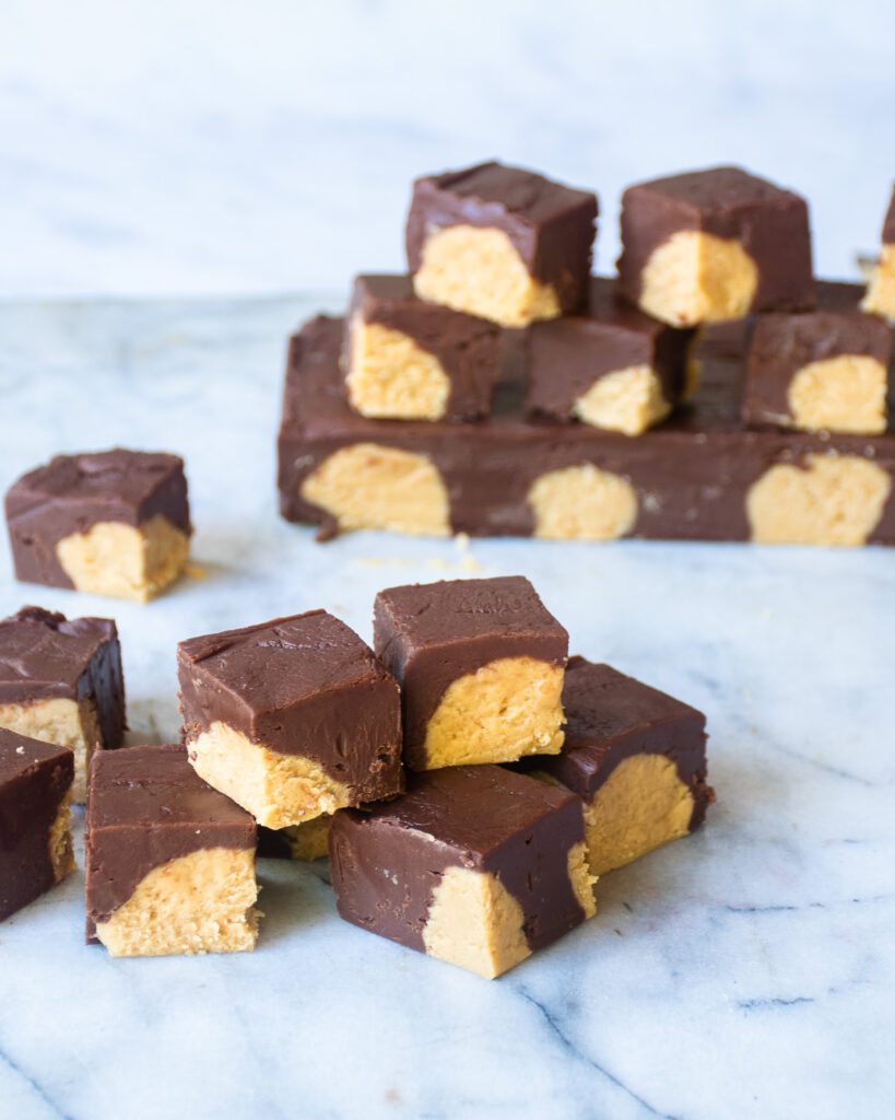 Small stacks of buckeye fudge on a marble board.