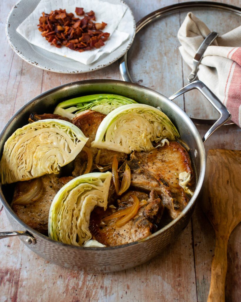https://bluejeanchef.com/uploads/2023/01/Pork-Chops-with-Cabbage-and-Bacon-1280-8464-819x1024.jpg