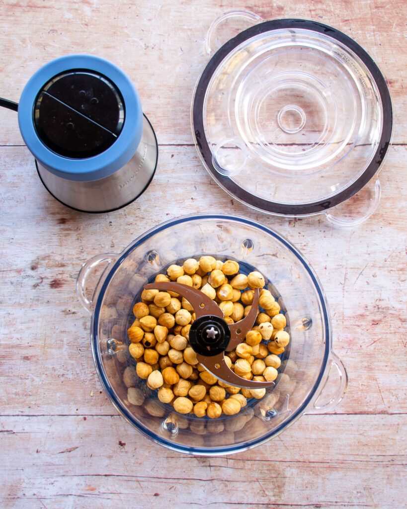 Looking down into a chopper with toasted hazelnuts ready to be ground into flour.