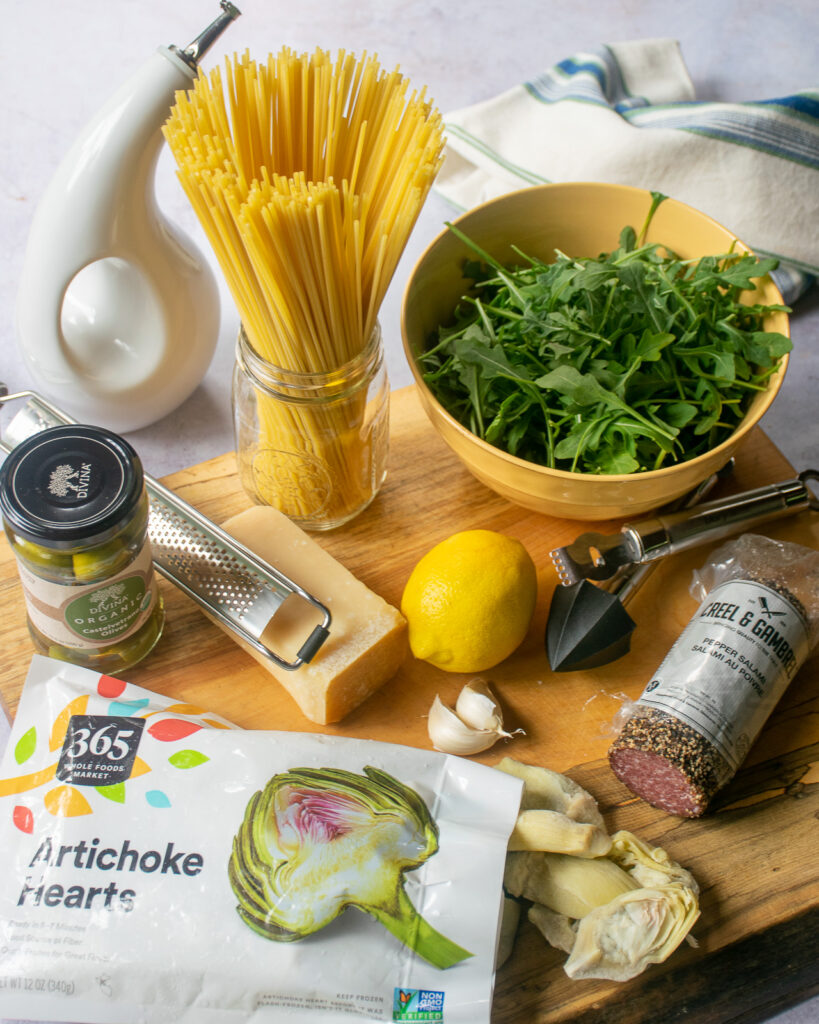 Ingredients for lemon pasta with salami on a cutting board.