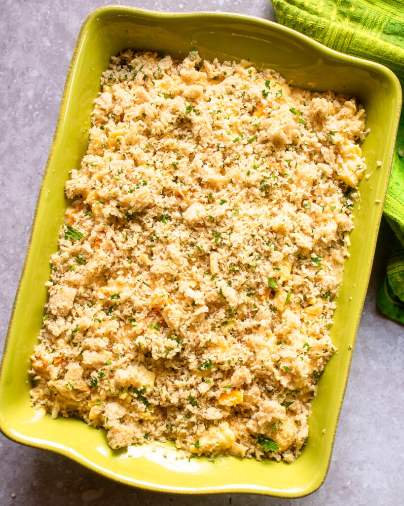 Butternut Squash apple mac and cheese in a green casserole before being baked.