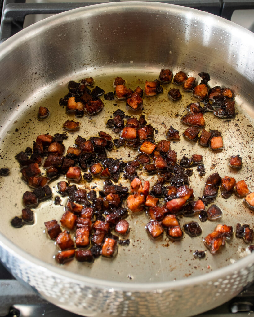 Pancetta browned in a saute pan.