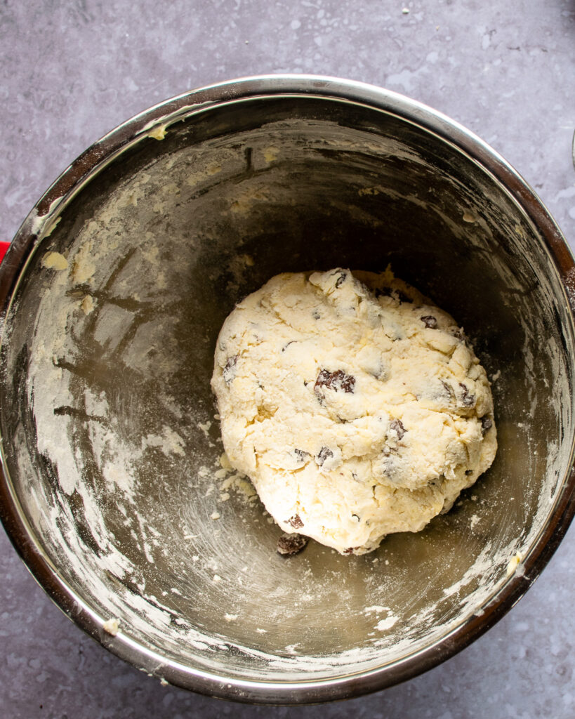 Cinnamon raisin biscuit dough in a stainless steel bowl.